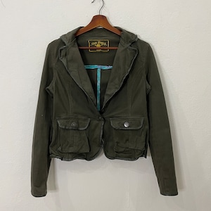 May include: A dark green blazer with a single button closure, two flap pockets, and a label that reads "Von Dutch" on the left side of the chest.