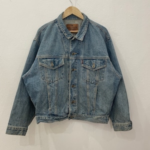 May include: A blue denim jacket with a Big John label on the left chest. The jacket has a button closure, two chest pockets, and two front pockets.