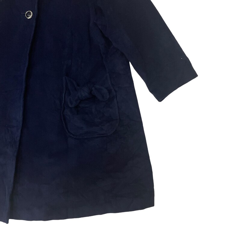 May include: A navy blue coat with a bow detail on the pocket.