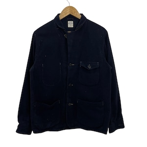 May include: A dark navy blue long-sleeve jacket featuring a shawl collar, a front button closure, and four pockets. The jacket includes a small chest pocket with a buttoned flap and three larger open pockets. A white brand label is visible at the neck.