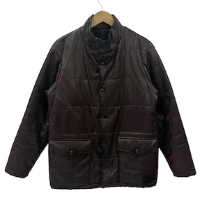 May include: A dark brown quilted jacket featuring a high collar, a front button closure, and two large flap pockets at the waist. The jacket has a smooth, semi-glossy finish and horizontal stitching throughout the body and sleeves.