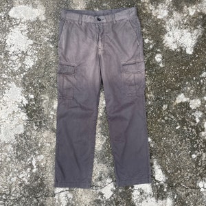 May include: Gray cargo pants with multiple pockets.