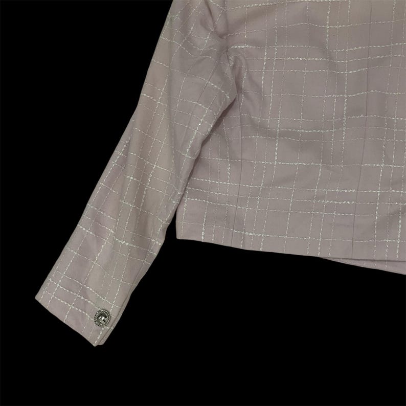 May include: A pale pink blazer with a white grid pattern. The blazer has a single button closure on the left side of the front.