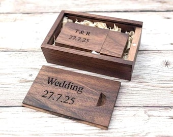 May include: A wooden USB flash drive and matching box set. The box is open, revealing the drive and a smaller wooden card. The card reads "Wedding 27.7.25". The USB drive is engraved with "T&R 27.7.25".