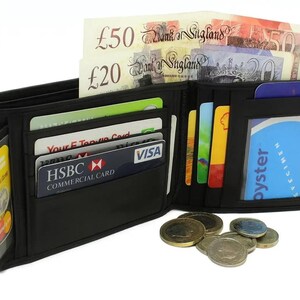 An open black leather wallet filled with credit cards, British pound banknotes, and coins scattered in front.