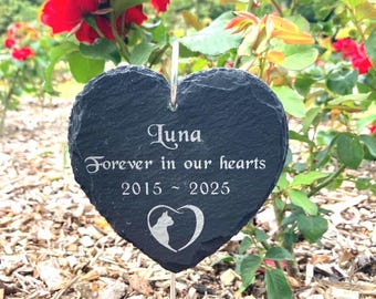 May include: A heart-shaped black slate memorial plaque featuring the engraved name Luna, the phrase Forever in our hearts, the years 2015 ~ 2025, and a cat silhouette inside a heart outline, suspended on a thin metal stake.