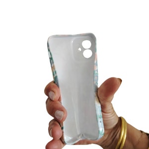 a person holding a cell phone in their hand