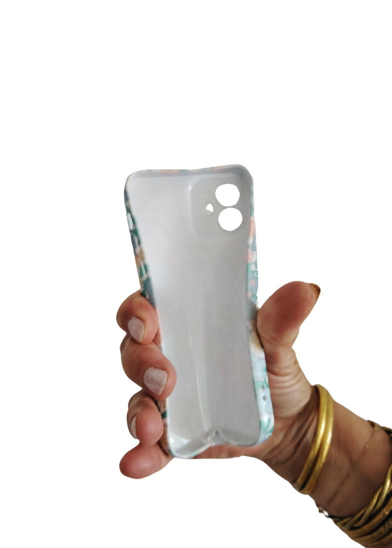 a person holding a cell phone in their hand