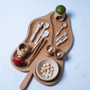 Open ended wooden kitchen utensils toys for kids. Montessori treasure basket for role play and sensory play