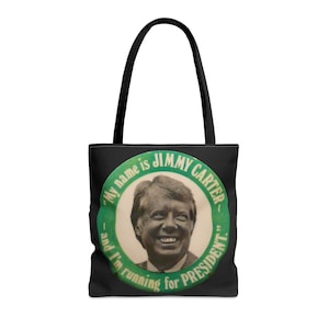 May include: Black tote bag with a green and white button featuring a portrait of Jimmy Carter and the text "My name is JIMMY CARTER and I'm running for PRESIDENT."