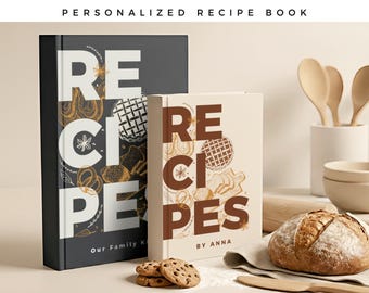 May include: Two hardcover recipe books with white and brown text. The larger book is black with white text reading RECIPES and Our Family K. The smaller book is cream with brown text reading RECIPES and BY ANNA. Both feature line art of baked goods.
