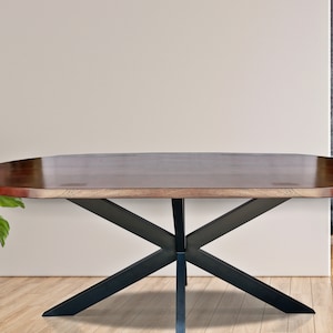 May include: A large oval wooden dining table with a dark brown finish and a black metal X-shaped base.