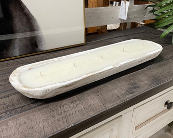 May include: White ceramic dough bowl candle with four wicks. The candle is sitting on a dark wood surface.