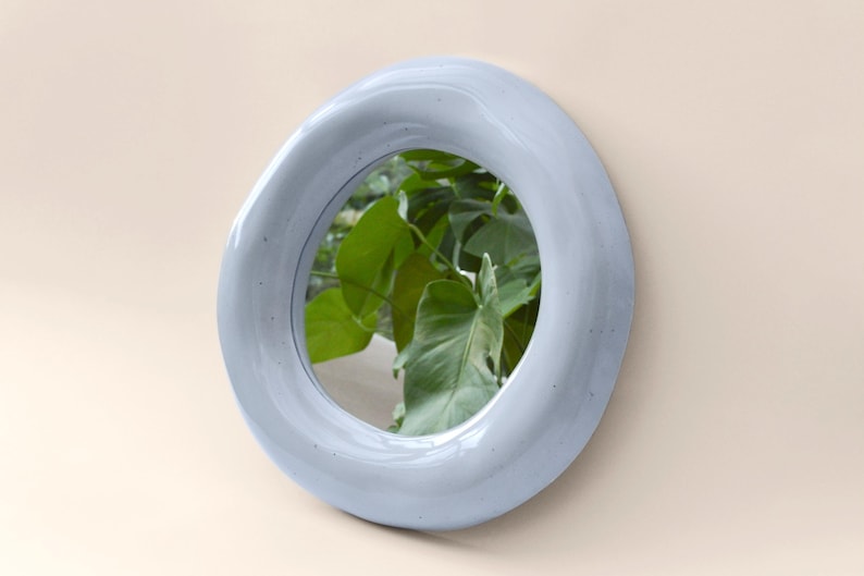 May include: A set of three ceramic mugs with a speckled, matte finish. The mugs are in shades of cream, light gray, and dark gray. Each mug has a simple, minimalist design, perfect for coffee or tea.