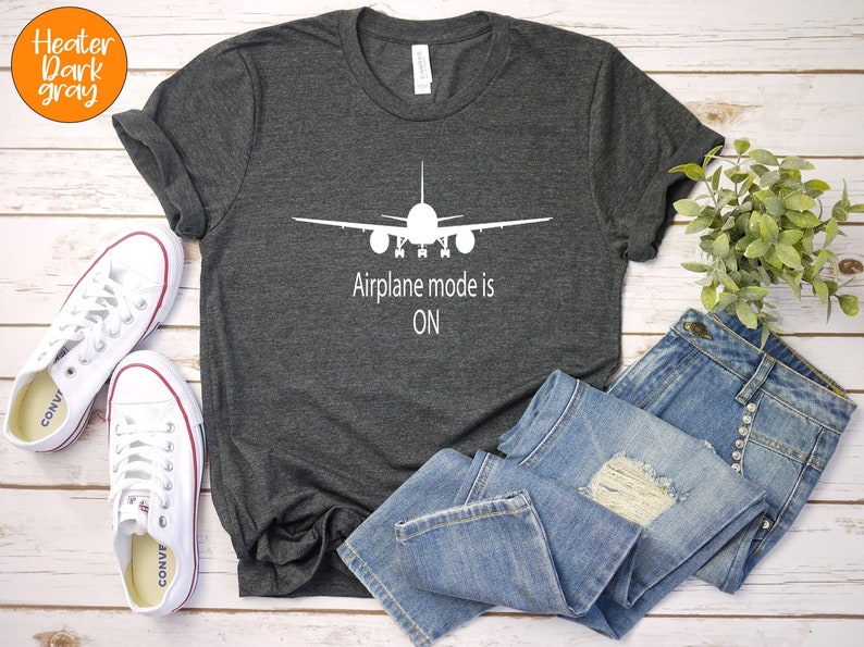 May include: A dark heather grey t-shirt with a white airplane graphic and the text "Airplane mode is ON".