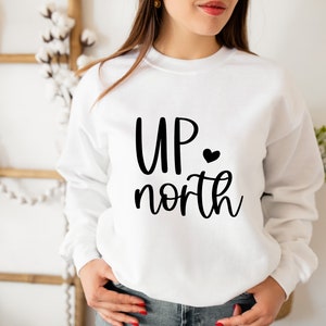 May include: White sweatshirt with black text that reads "UP north" with a small black heart after "UP".