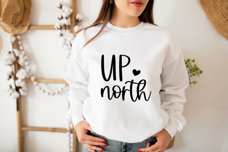 May include: White sweatshirt with black text that reads "UP north" with a small black heart after "UP".