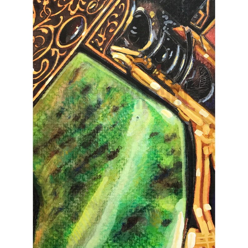 May include: Close-up of a green gemstone set in a gold frame with intricate details. The gemstone has a mottled green and black pattern.
