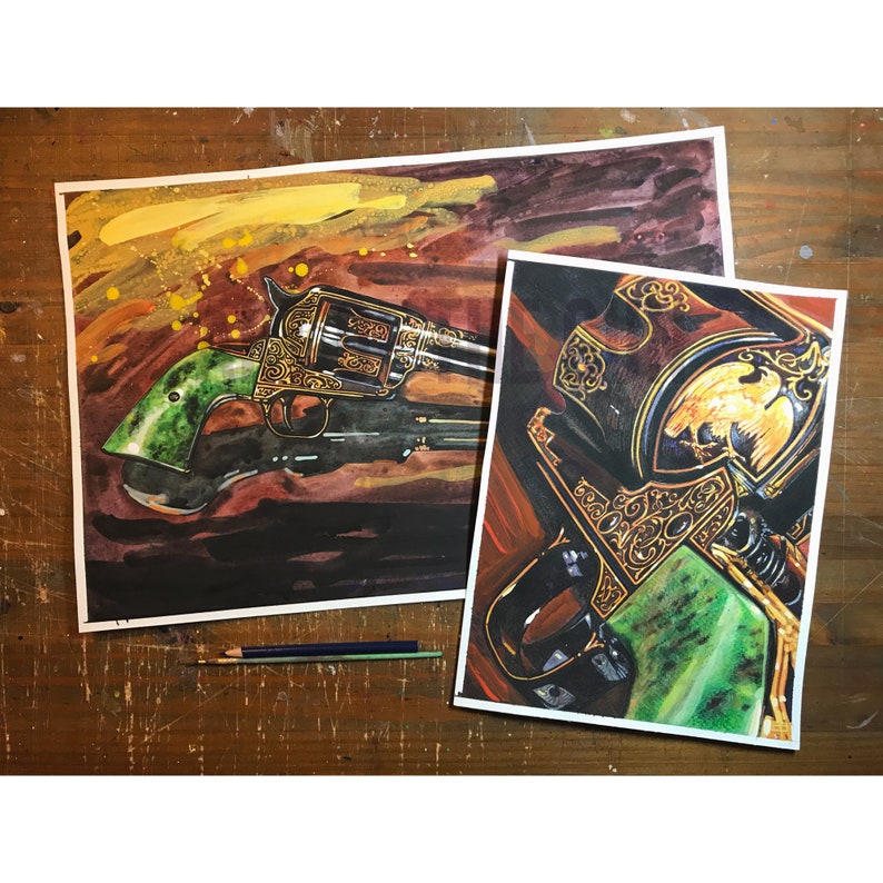 May include: Two watercolor paintings of a revolver and a gun holster. The revolver has a green handle and gold filigree detailing. The holster features an eagle emblem and gold accents. The background is a mix of dark and warm colors.