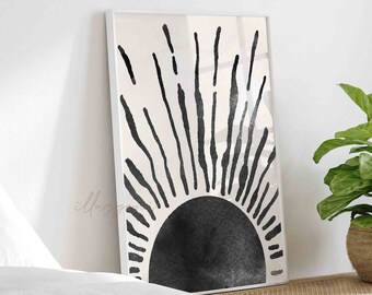 May include: A black and white minimalist sunburst print in a white frame. The sunburst is a stylized sun with a black circle and radiating lines.