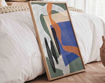 May include: Abstract art print in a wooden frame with a green, blue, orange, and white color scheme. The print is leaning against a white bed with a wooden headboard.