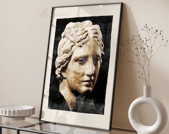 May include: A framed print of a black and white illustration of a woman's face. The woman's face is sculpted in a classical style and is painted in shades of beige and brown.