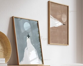 May include: Two framed abstract art prints with a minimalist design. The prints feature a white shape with a black airplane flying over a blue and brown background. The prints are in wooden frames.