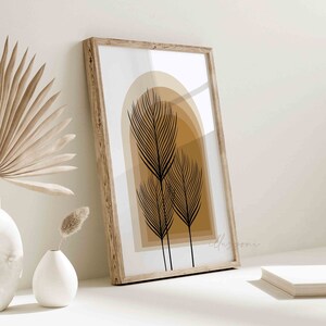 May include: A framed print with a minimalist design featuring three black stylized palm trees against a background of beige and brown arches.