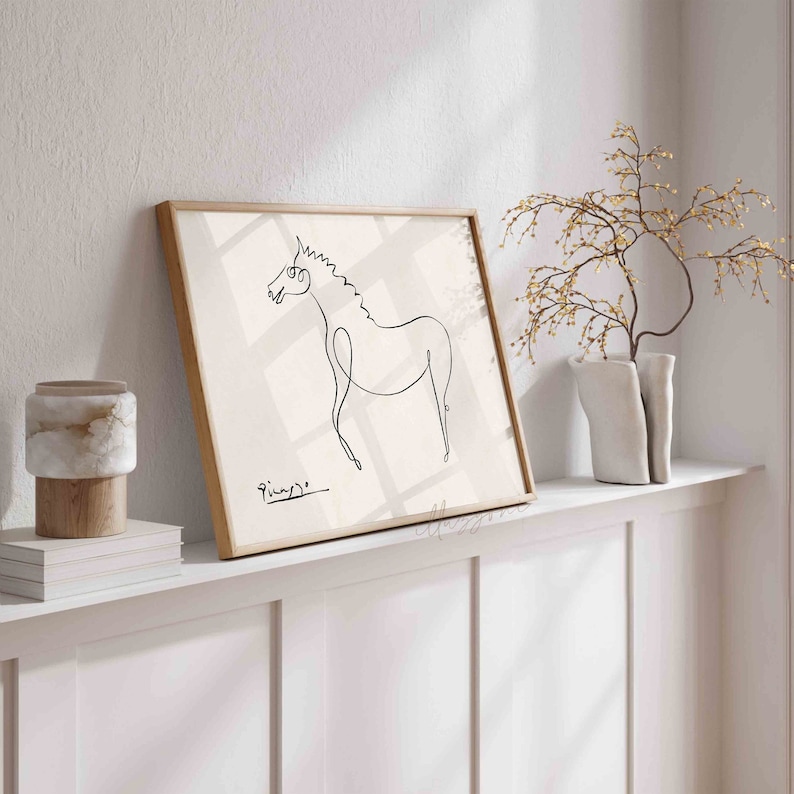 May include: A framed black and white line drawing of a horse, with the artist's signature "Picasso" in the bottom left corner.