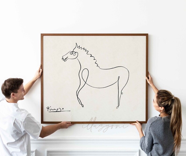 May include: Two people are hanging a framed black and white line drawing of a horse on a white wall. The drawing is signed "Picasso".