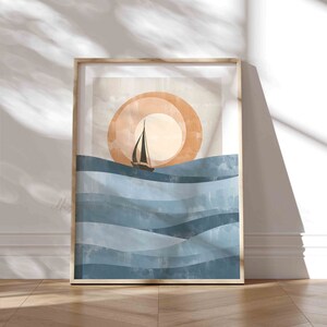May include: Abstract art print featuring a sailboat on a blue and white wavy ocean with a large orange sun in the background.