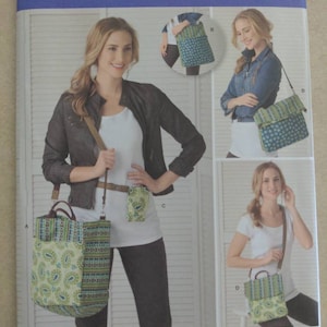 May include: Simplicity pattern 2168 features a tote bag, crossbody bag, and small pouch. The bags have a paisley and polka dot design in shades of green, blue, and cream. The pattern includes the text "ONE SIZE" and "Simplicity".