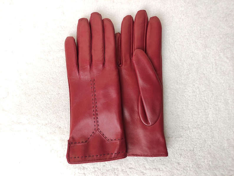 Puede incluir: Una taza de cer&aacute;mica blanca con un asa negra y el texto "But first, coffee" en un estilo manuscrito. La taza est&aacute; sobre una superficie blanca. La taza mide 10 cm de alto.