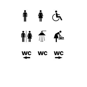 Pode incluir: Sinais de banheiro em preto e branco com símbolos para homens, mulheres, pessoas em cadeira de rodas, um chuveiro, uma mesa de fraldas e o texto "WC" com setas indicando a direção.