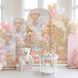 May include: A set of five arched backdrop panels featuring a pastel illustration of hot air balloons, a carousel, and a bridge, accompanied by a white teddy bear on a gift box and a white round table with small desserts, surrounded by pink balloons.