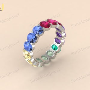 Oval-shaped multi sapphire wedding band featuring rainbow sapphires in 14k gold or sterling silver. 1