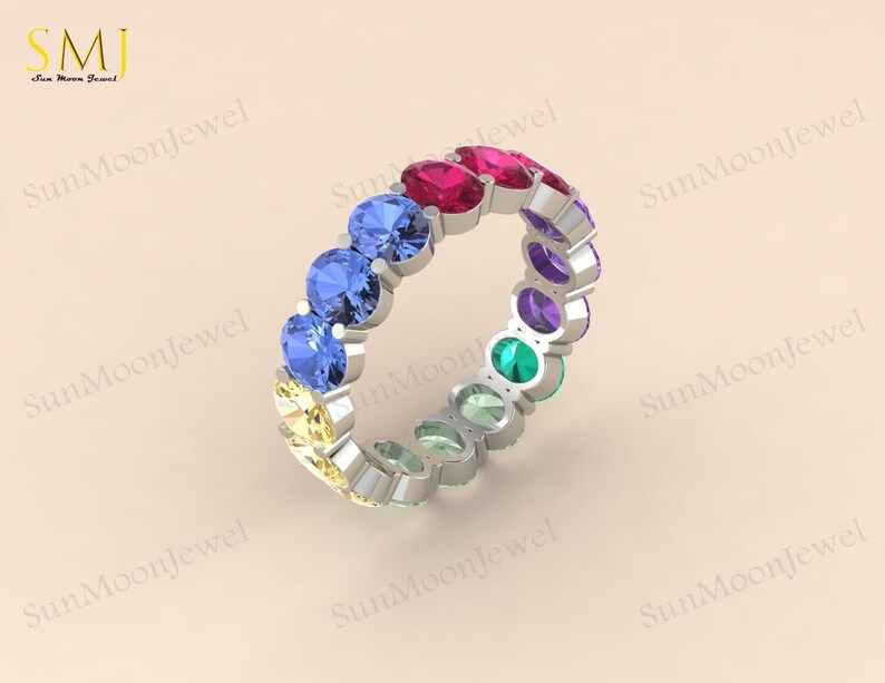 Oval-shaped multi sapphire wedding band featuring rainbow sapphires in 14k gold or sterling silver. 1