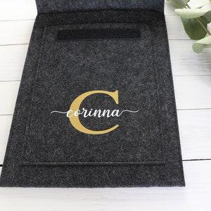 May include: A gray felt storage pouch with a gold letter C and the name "corinna" in white script.