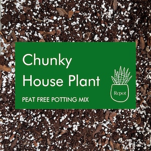 May include: Close-up of chunky house plant potting mix. The mix is a blend of dark brown soil, white perlite, and bark pieces. A green rectangle with white text reads "Chunky House Plant PEAT FREE POTTING MIX" with a plant illustration.