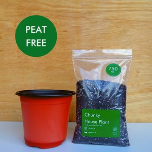 May include: A red plant pot with a black rim is next to a clear bag of chunky house plant potting mix. The bag contains 750 ml of mix and has a green label. A green circle with the words "PEAT FREE" is also visible.