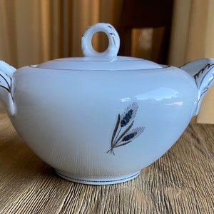 May include: White porcelain sugar bowl with a gold trim and a wheat design. The lid has a gold knob.