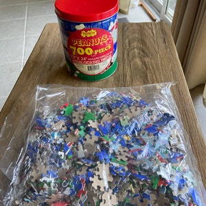 Vintage Peanuts puzzle in tin