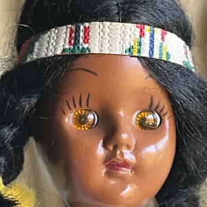 Vintage small doll with leather outfit