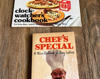 May include: Two vintage cookbooks. The top one is titled "clock-watcher's cookbook" with the tagline "For busy days - quick, simple meals from Minute Rice". The bottom one is titled "CHEF'S SPECIAL A Mini-Cookbook for Busy Ladies".