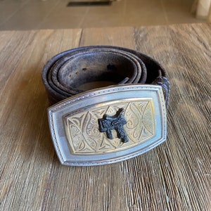 Vintage cowboy saddle belt buckle with leather belt
