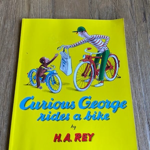 Vintage Curious George rides a bike book