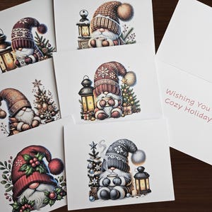 May include: A collection of holiday greeting cards featuring illustrations of gnomes in winter attire. The gnomes are depicted with cozy hats, holding mugs, and surrounded by festive decorations like lanterns and Christmas trees. One card reads "Wishing You a Cozy Holiday."