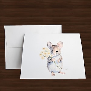 May include: A watercolor illustration of a mouse holding a bouquet of yellow flowers. The mouse has gray and brown fur and large ears. A white envelope and card are in the background.