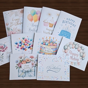 May include: A collection of watercolor birthday cards with various designs. Some cards feature balloons, cakes, and floral arrangements. The words "Happy Birthday" are written on several cards in elegant script.