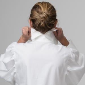 May include: A white collared shirt with puffed sleeves. The shirt is made of a soft, lightweight fabric.